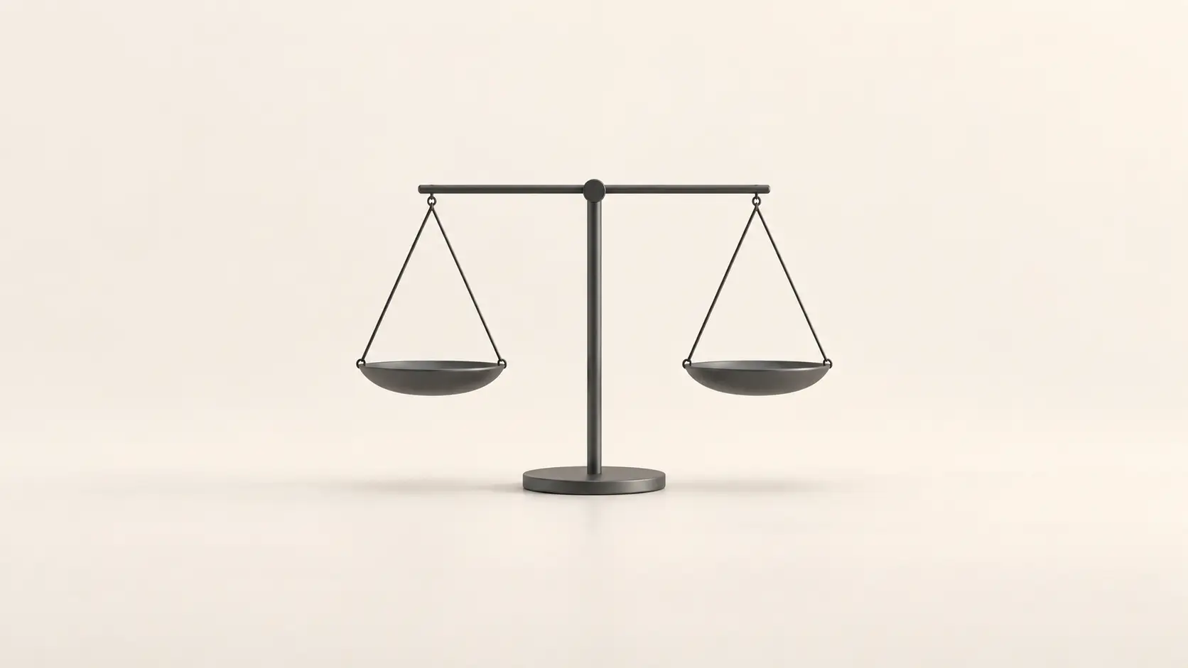 A single small pair of matte graphite legal scales with empty pans on an off-white background.